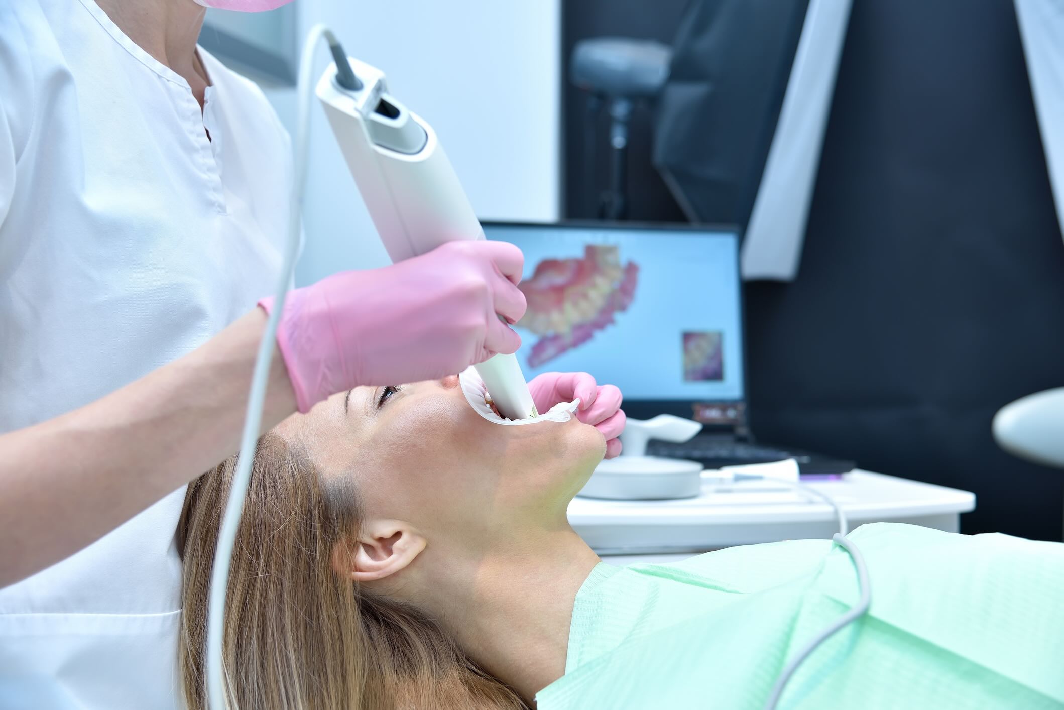 Dentist scaning patient's  jaw.